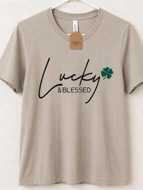 Woman’s New Bella Canvas Taupe Tee with Black Script and Green Clover